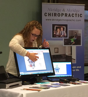 Jenn explains the spinal screening results for Akridge Chiropractic.